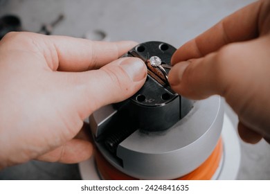 Goldsmith hands with ring. Work in process.