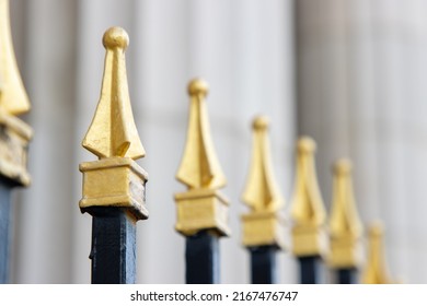 Gold-tipped Security Fence Surrounding Classical Government Building