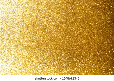 Gold,yellow abstract light background,Gold bokeh shining lights,sparkling glittering Christmas lights.Season greeting background.New year Luxury backdrop image.Blurred abstract holiday background.