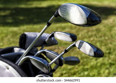 Golf Bag With Clubs On Green Field, Close Up

