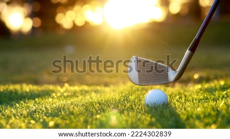 Golf ball close up on tee grass on blurred beautiful landscape of golf background. Concept international sport that rely on precision skills for health relaxation...	