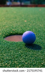 Golf Ball At The Edge Of Hole On Putt Putt Course