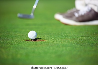 Golf Ball Falling Into Hole After Putt On Green