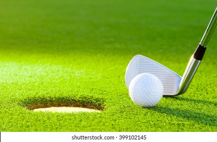 Golf Ball From The Hole With The Putter On Golf Turf