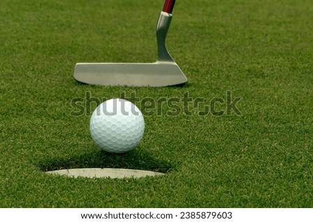 Golf ball just missing the cup