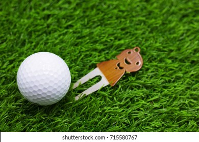 Golf Ball With Marker Are On Green Grass