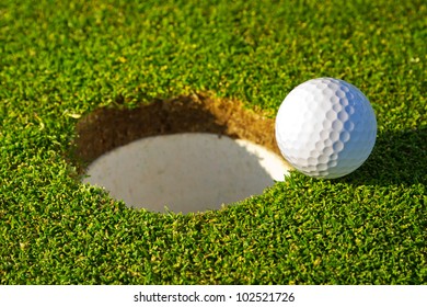 Golf Ball Near The Hole