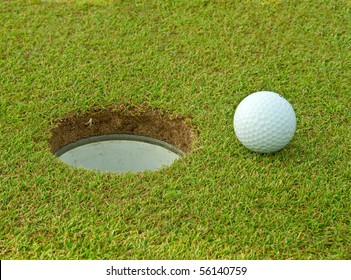 Golf Ball Near The Hole