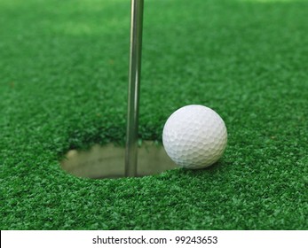 Golf Ball Near The Hole