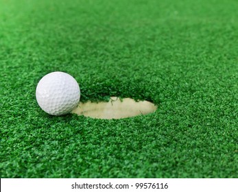 Golf Ball Near The Hole