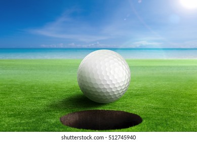 Golf Ball On Edge Of The Hole. Shallow Depth Of Field. Focus On The Ball And The Hole.