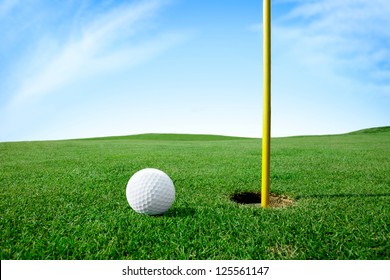 Golf Ball On Green Grass Next Hole