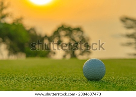 Golf ball on green grass ready to be shot at golfcourt.