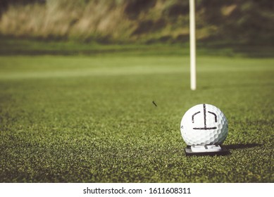 Golf Ball On Green. With Marker