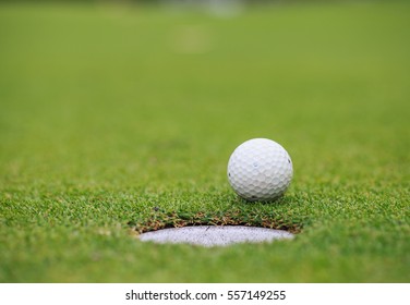 Golf Ball On Lip Of Cup