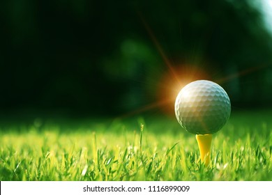 Golf Ball On Tee In Beautiful Golf Course At Sunset Background. Golf Ball On Green In Golf Course At Thailand