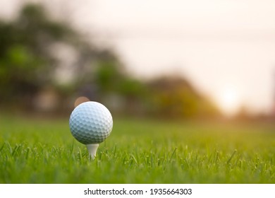 golf ball on tee in a beautiful golf course with morning sunshine.Ready for golf in the first short.Sports that people around the world play during the holidays for health.