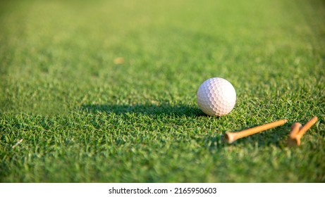 Golf ball on tee on golf course. Hobby in holiday and vacations on club golf. Lifestyle and Sport Concept