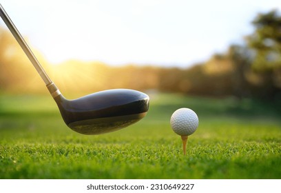 Golf ball on tee and golf drivers at golf course with sunrise background. - Powered by Shutterstock