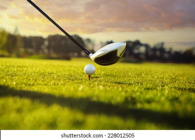 Golf Ball On Tee In Front Of Driver