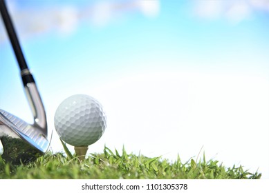 Golf Ball On Tee With Iron Club Head Cloud Sky Background