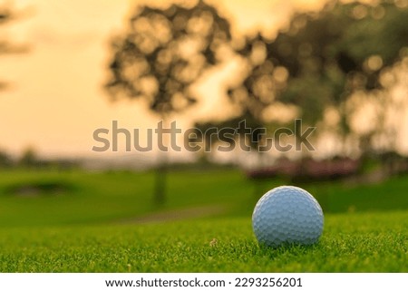 Golf ball on tee ready to be shot at golfcourt.