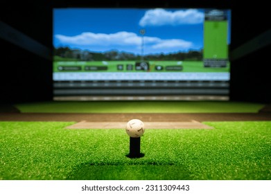 Golf ball on tee at simulator - Shutterstock ID 2311309443
