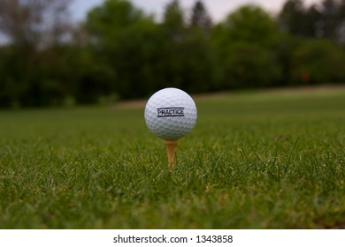 Golf Ball with 'Practice' on it on a golf tee