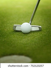 A Golf Ball Is Putted With A Golf Iron, Golf Club. Putt With Putter. Golf Ball On Green.