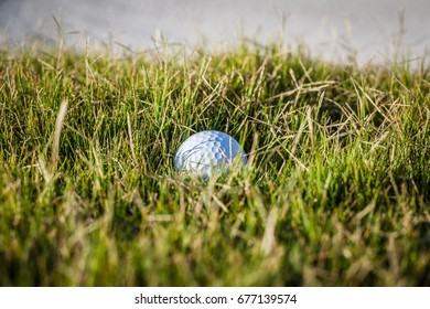 Golf Ball In The Rough Grass On A Golf Course