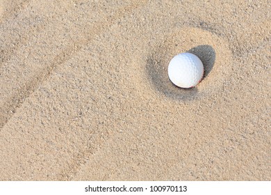 Golf Ball In Sand Bunker.