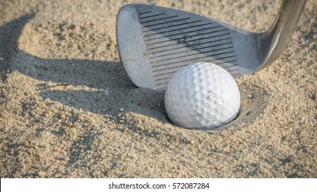 Golf Ball In Sand Trap With Pitching Wedge 