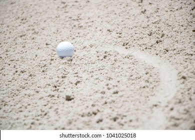 Golf Ball Stuck In A Sand Trap
