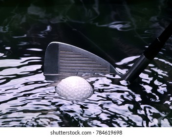 Golf Ball Stuck In A Water Hazzard With Iron Club