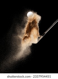 Golf ball tee explode from sand bunker. Golfer hit ball with club to sand explosion to green. Golf club hit ball tee in sand wedge bunker explosion. Black background isolated freeze motion