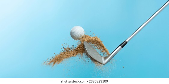 Golf ball tee explode from sand bunker. Golfer hit ball with club to sand explosion to summer sky. Golf club hit ball tee in sand wedge bunker explosion. Blue sky background isolated freeze motion
