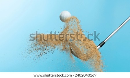 Golf ball tee explode from sand bunker. Golfer hit ball with club to sand explosion to summer sky. Golf club hit ball tee in sand wedge bunker explosion. Blue sky background isolated freeze motion