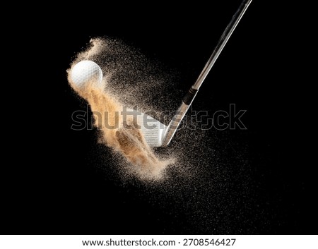 Golf ball tee explode from sand bunker. Golfer hit ball with club to sand explosion to green. Golf club hit ball tee in sand wedge bunker explosion. Black background isolated freeze motion