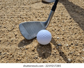 Golf Ball Trapped With Wedge Of Sand About To Hit Golf Ball. Sand Golf