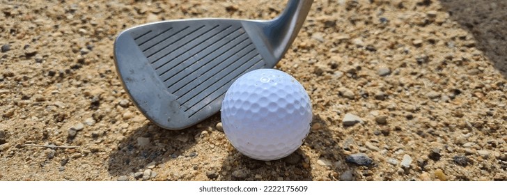 Golf Ball Trapped With Wedge Of Sand About To Hit Golf Ball. Sand Golf