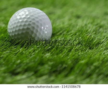 Golf balls on green grass