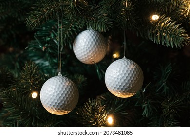 Golf balls as a xmas ornament in fir tree - Shutterstock ID 2073481085