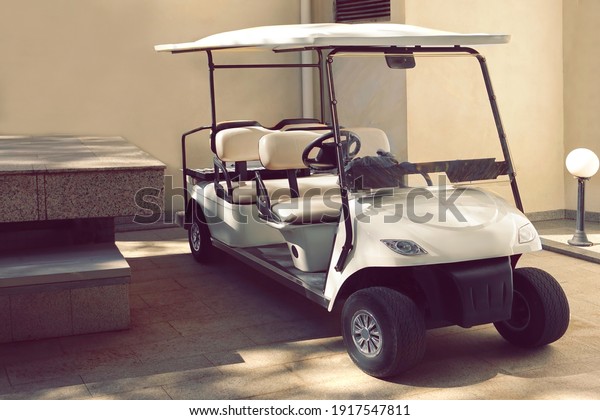 Golf Car. Electrical Hotel Or\
Resort Service Car Closeup. Long Electric Shuttle Passenger\
Bus.