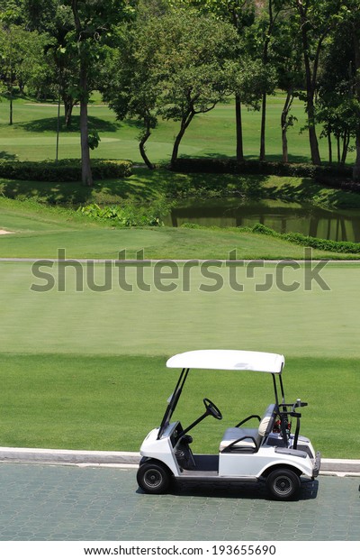 golf car in green golf\
course