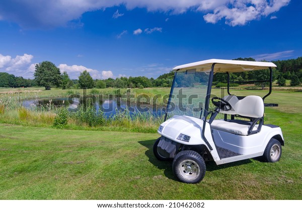 Golf car near the water\
pond