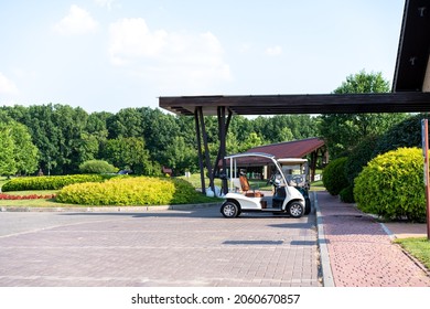 Golf car standing parking golf club Warm summer day Luxury lifestyle concept - Powered by Shutterstock