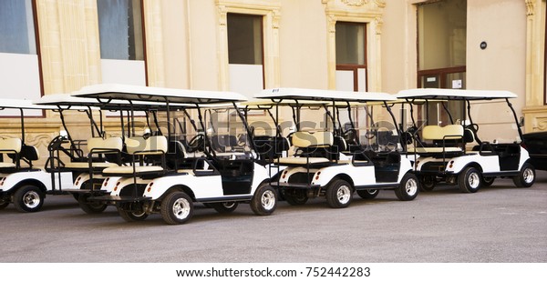 Golf cars are in the\
yard