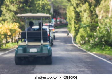 Golf Cart Driving On The Road.