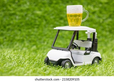 Golf cart with glass of beer are on green grass, average golfers, it is common to have a few drinks during a round. But could it possibly help you play better golf. 