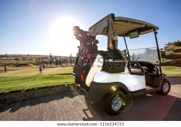 Golf cart on golf\
course.